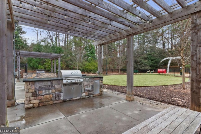 view of patio / terrace with a pergola, area for grilling, and a grill