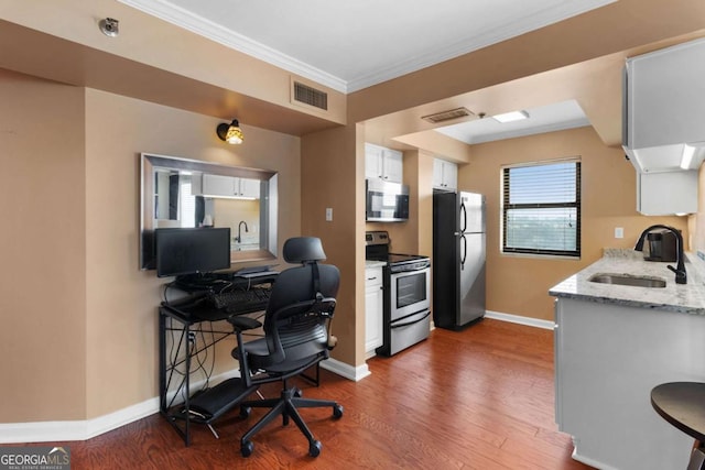 office area featuring dark hardwood / wood-style flooring, sink, and ornamental molding