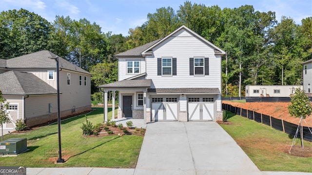 view of front of property featuring a garage and a front lawn