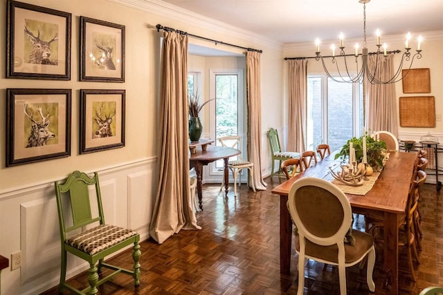 dining area with ornamental molding, dark parquet floors, and a notable chandelier