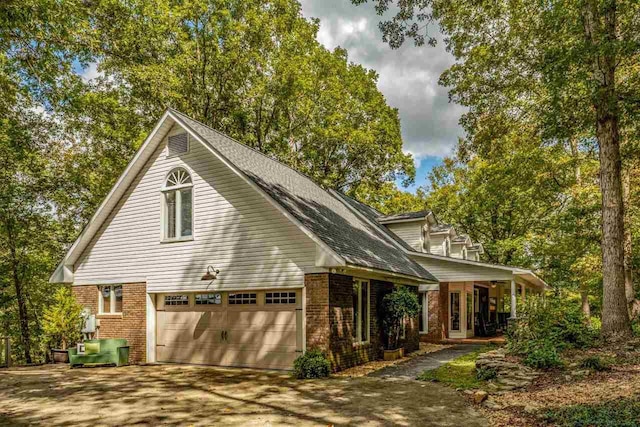 view of front of house featuring covered porch and a garage