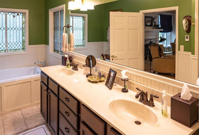 bathroom featuring tile patterned flooring, vanity, and a bathtub