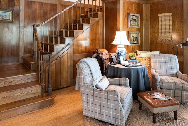 sitting room featuring wood walls and light hardwood / wood-style floors