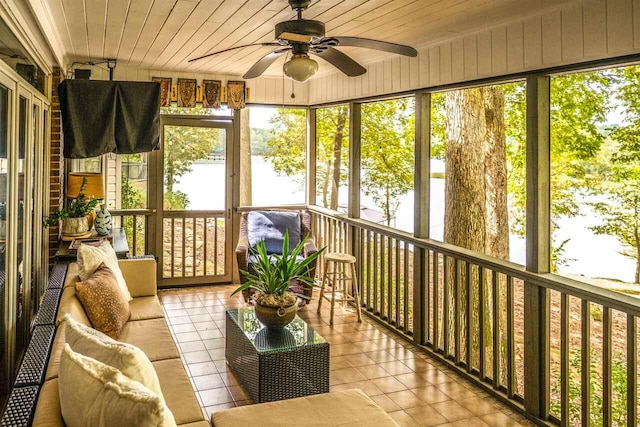 unfurnished sunroom with ceiling fan and wood ceiling