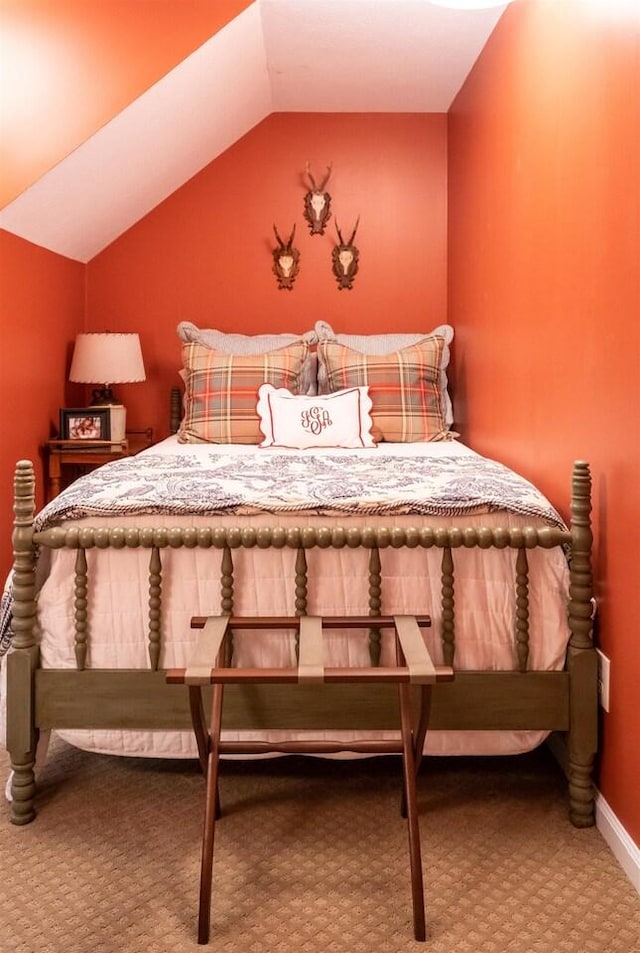 bedroom with carpet flooring and vaulted ceiling