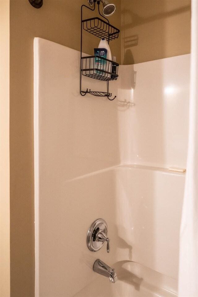 interior details featuring bathing tub / shower combination