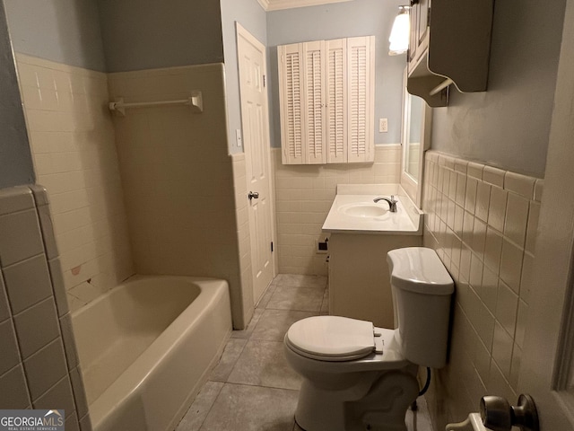 bathroom featuring tile patterned floors, vanity, toilet, and tile walls