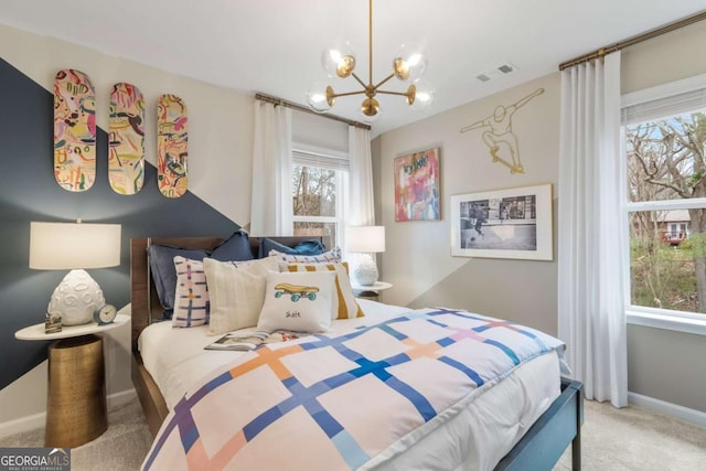 bedroom with carpet flooring, a notable chandelier, and multiple windows