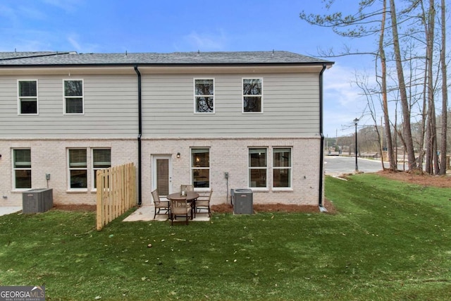 back of house with a yard, central AC unit, and a patio area