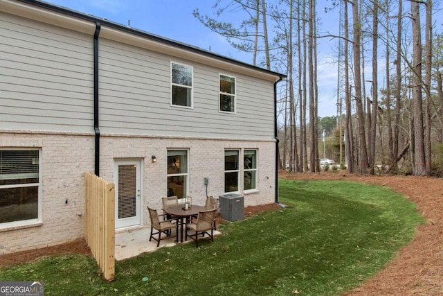 back of property featuring a lawn, a patio area, and central air condition unit