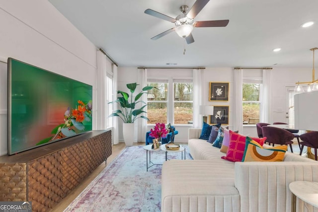 living room featuring hardwood / wood-style flooring and ceiling fan