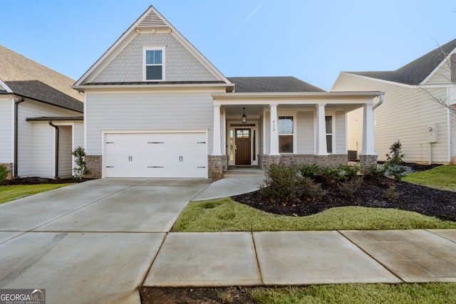 craftsman house with a porch and a garage