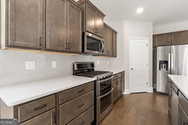 kitchen featuring decorative backsplash, appliances with stainless steel finishes, and dark brown cabinetry