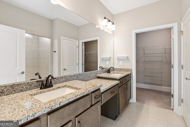 bathroom featuring tile patterned floors, vanity, and tiled shower