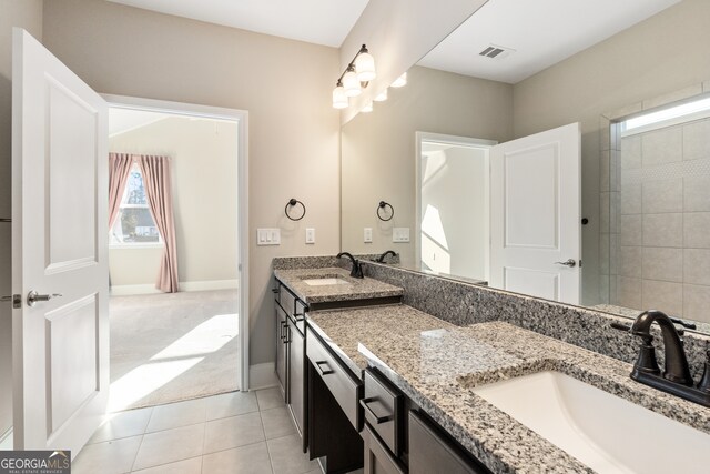 bathroom with tile patterned floors and vanity