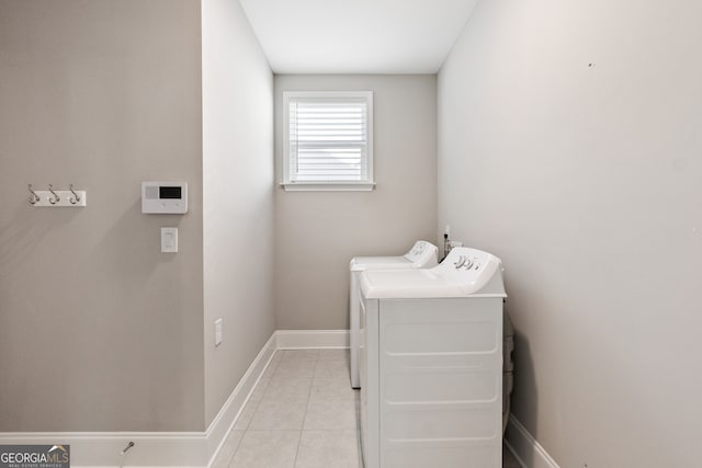 laundry area with light tile patterned floors and washing machine and clothes dryer