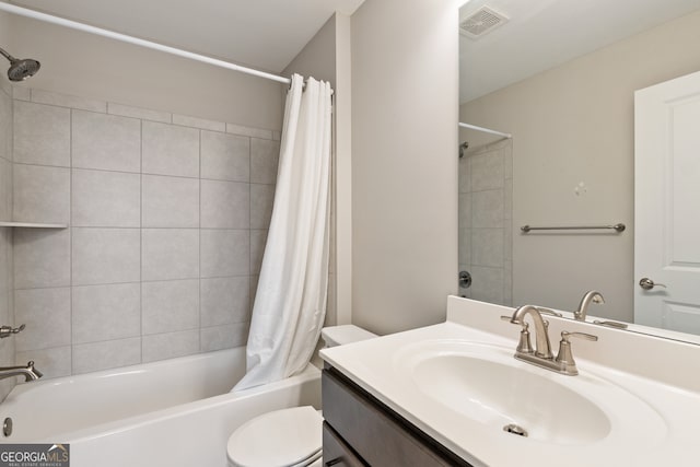 full bathroom with shower / bath combo with shower curtain, vanity, and toilet