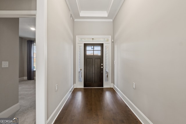 foyer with dark wood-type flooring and ornamental molding