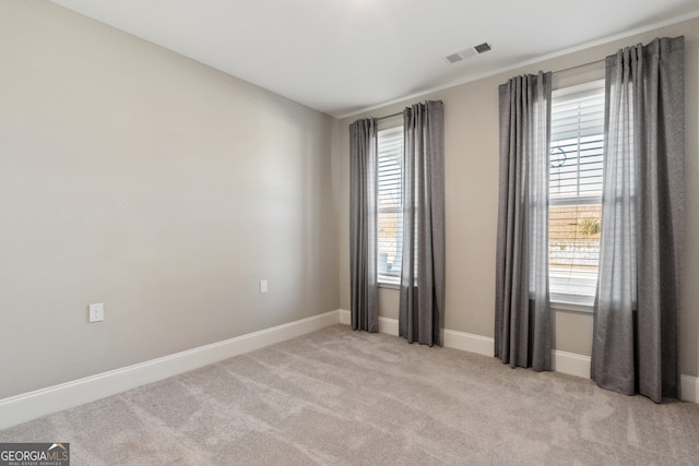 spare room with light colored carpet