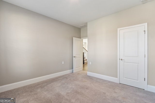 unfurnished bedroom featuring light colored carpet