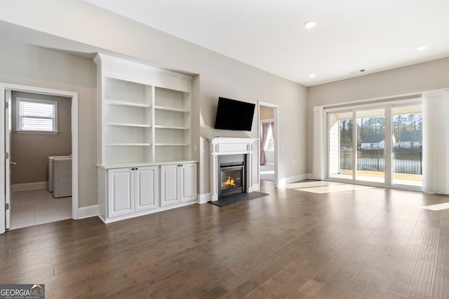 unfurnished living room with plenty of natural light and wood-type flooring