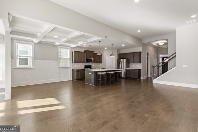 unfurnished living room featuring beamed ceiling, dark hardwood / wood-style flooring, coffered ceiling, and sink