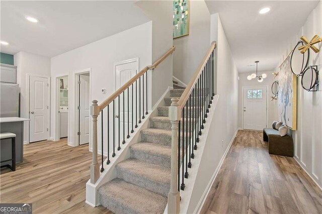 entryway featuring a chandelier and light wood-type flooring