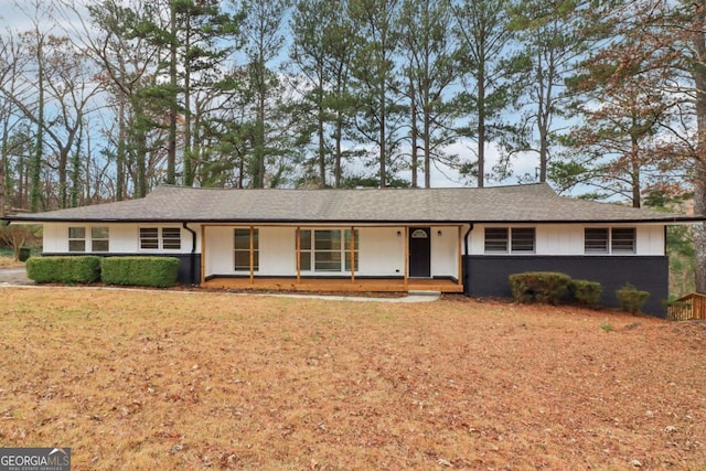 ranch-style house with a porch and a front yard