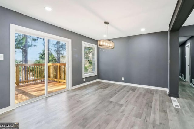 unfurnished dining area with light wood-type flooring