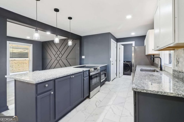 kitchen featuring sink, decorative light fixtures, white cabinets, washer / dryer, and stainless steel range with electric cooktop