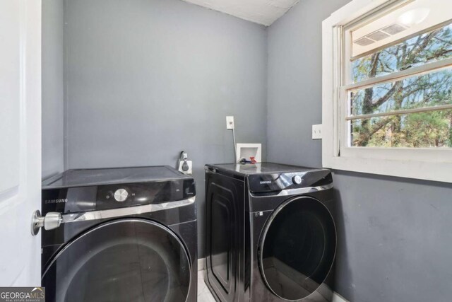 laundry room featuring washing machine and clothes dryer