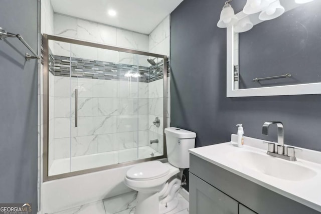 full bathroom with vanity, toilet, and shower / bath combination with glass door