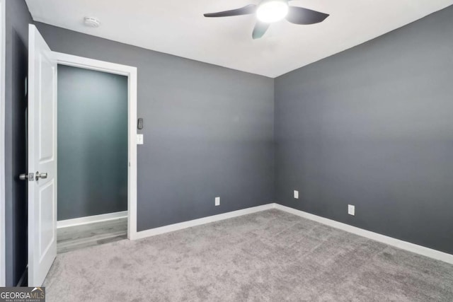 unfurnished room with ceiling fan and light colored carpet