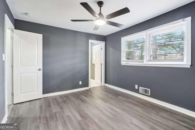 unfurnished bedroom featuring hardwood / wood-style floors and ceiling fan