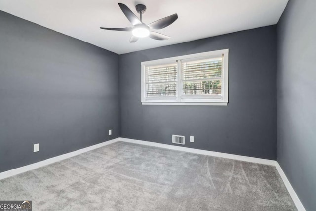 spare room featuring ceiling fan and light colored carpet