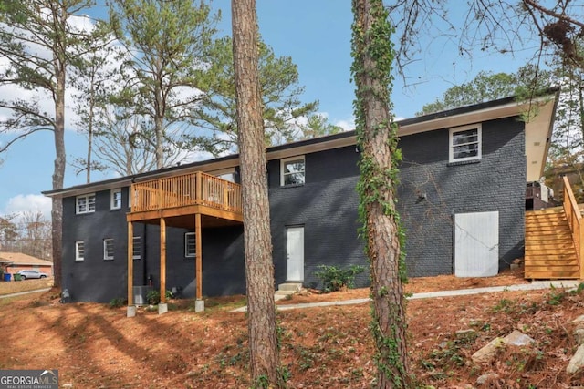 back of house with central AC and a deck