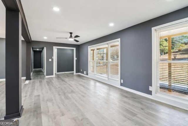 unfurnished living room featuring light hardwood / wood-style floors and ceiling fan