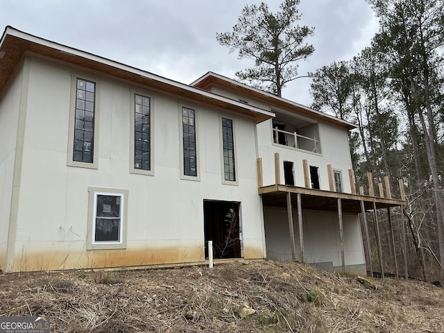 rear view of property featuring a balcony