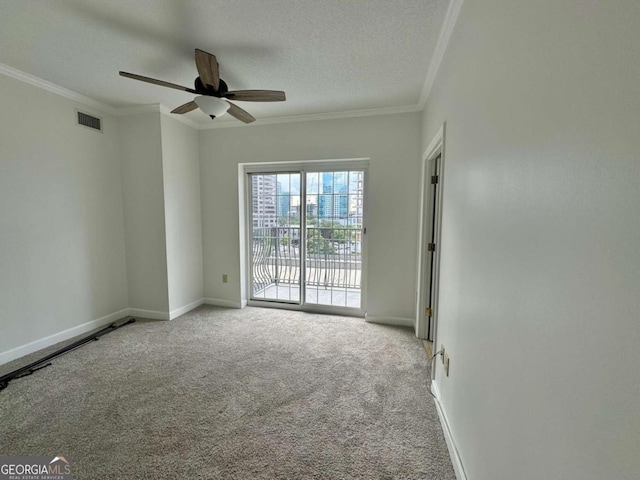 unfurnished room with carpet flooring, a textured ceiling, ceiling fan, and crown molding