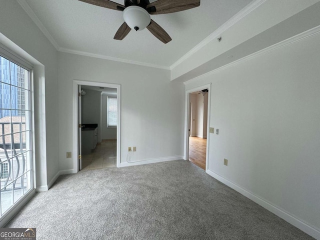 unfurnished bedroom with multiple windows, light colored carpet, ceiling fan, and crown molding