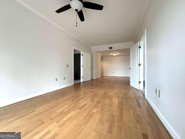 unfurnished room with ceiling fan, light wood-type flooring, and ornamental molding