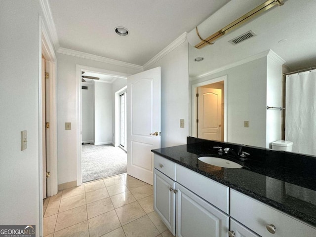 bathroom with tile patterned flooring, vanity, ceiling fan, and crown molding