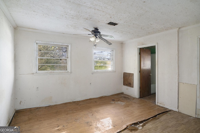 unfurnished room featuring ceiling fan, crown molding, and wood-type flooring