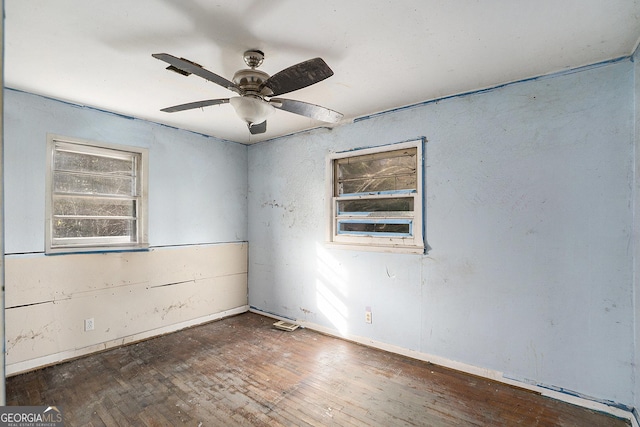 empty room featuring ceiling fan and dark wood-type flooring