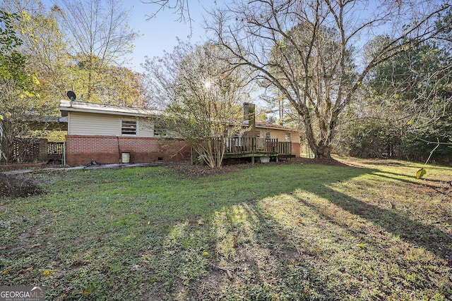 view of yard featuring a wooden deck