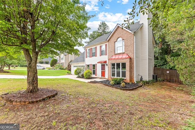 view of front of house with a garage and a front lawn