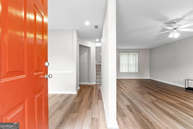 interior space featuring ceiling fan, hardwood / wood-style floors, and a textured ceiling