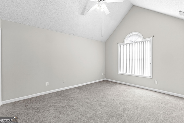 unfurnished room featuring lofted ceiling, carpet, a textured ceiling, and ceiling fan