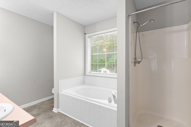 full bathroom featuring plus walk in shower, vanity, a textured ceiling, and toilet