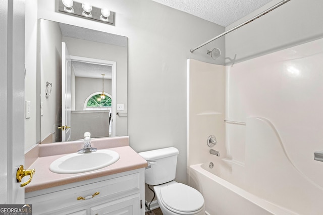 full bathroom featuring shower / tub combination, vanity, a textured ceiling, and toilet